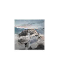 a photo of a mountain with clouds in the background