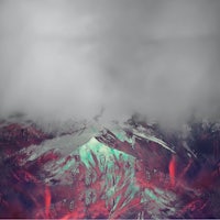an abstract image of a mountain covered in clouds